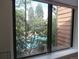 View of community pool and trees from interior window at 2215 S Buckley Rd # 201, Aurora, CO 80013