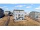 Backyard view of a two-story home with a patio, balcony, and a fence surrounding the property at 4548 River Highlands Loop, Elizabeth, CO 80107