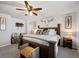 Comfortable bedroom featuring a large bed, ceiling fan, and rustic decor at 4548 River Highlands Loop, Elizabeth, CO 80107