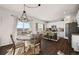 Dining area featuring hardwood floors, stylish lighting, and an adjacent kitchen at 4548 River Highlands Loop, Elizabeth, CO 80107