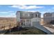 Charming two-story home boasts a front porch and two-car garage, set against a picturesque prairie backdrop at 4548 River Highlands Loop, Elizabeth, CO 80107