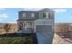 Charming two-story home with an attached two-car garage and covered front porch at 4548 River Highlands Loop, Elizabeth, CO 80107