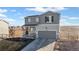 Charming two-story home with a covered porch, gray siding, manicured lawn, and mountain views at 4548 River Highlands Loop, Elizabeth, CO 80107