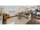 Bright living room features a comfortable sectional sofa, area rug, and windows with views at 4548 River Highlands Loop, Elizabeth, CO 80107