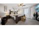 Spacious main bedroom with gray walls, ceiling fan, and a king bed with wooden headboard and mountain view TV at 4548 River Highlands Loop, Elizabeth, CO 80107