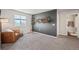 Spacious room featuring a comfortable chair, mounted decorations and a view of the outdoors at 4548 River Highlands Loop, Elizabeth, CO 80107