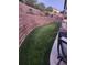 Spacious backyard featuring a tiered retaining wall and lush green lawn at 21028 E Saratoga Ave, Aurora, CO 80015