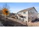 Inviting home exterior with blue shutters, patio, and a landscaped backyard at 21028 E Saratoga Ave, Aurora, CO 80015