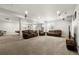 Spacious basement with plush carpeting, comfortable seating, and ample lighting at 21028 E Saratoga Ave, Aurora, CO 80015
