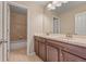 Bathroom featuring a double sink vanity with wood cabinets, tile floors, and a separate shower and bathtub at 21028 E Saratoga Ave, Aurora, CO 80015