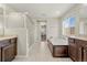 Bright bathroom features a soaking tub, step-in shower, and large window at 21028 E Saratoga Ave, Aurora, CO 80015