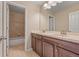 Well-maintained bathroom with dual sinks, vanity, and tiled shower/tub combo at 21028 E Saratoga Ave, Aurora, CO 80015