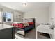 Cozy bedroom features a bed, floating shelves, carpet flooring and natural light at 21028 E Saratoga Ave, Aurora, CO 80015