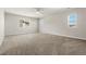 Spacious carpeted bedroom with multiple windows offering natural light at 21028 E Saratoga Ave, Aurora, CO 80015