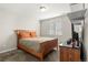 Cozy bedroom with neutral-colored walls and carpet, with wooden bed frame and minimal decor at 21028 E Saratoga Ave, Aurora, CO 80015