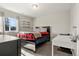 Cozy bedroom featuring modern furnishings, a window, and neutral tones at 21028 E Saratoga Ave, Aurora, CO 80015