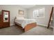 This bedroom features neutral walls, plush carpet, and a classic wood wardrobe with a mirror at 21028 E Saratoga Ave, Aurora, CO 80015