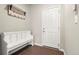 Inviting entryway with coat rack, bench, and white door at 21028 E Saratoga Ave, Aurora, CO 80015