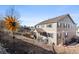 This home features stylish siding, complementing blue shutters, and lush landscaping at 21028 E Saratoga Ave, Aurora, CO 80015