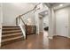 Spacious foyer featuring hardwood floors, staircase, and natural light at 21028 E Saratoga Ave, Aurora, CO 80015