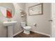 Stylish half bathroom with pedestal sink and decorative mirrors at 21028 E Saratoga Ave, Aurora, CO 80015