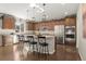 Bright kitchen with stainless appliances, a center island with barstool seating, and wood cabinets at 21028 E Saratoga Ave, Aurora, CO 80015