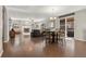 Open-concept living room with dining area, fireplace, and modern finishes at 21028 E Saratoga Ave, Aurora, CO 80015