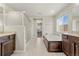 Luxurious main bathroom with a soaking tub, walk-in shower, and dual sink vanity at 21028 E Saratoga Ave, Aurora, CO 80015