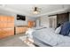 Bright main bedroom with a tray ceiling, a large dresser, and closet access at 21028 E Saratoga Ave, Aurora, CO 80015