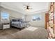 Spacious main bedroom with carpet flooring, ceiling fan, and bright natural light at 21028 E Saratoga Ave, Aurora, CO 80015