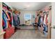 Large walk-in closet offers ample storage space and a window for natural light at 21028 E Saratoga Ave, Aurora, CO 80015