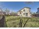 Expansive backyard with lush green grass, a patio, and mature trees for privacy at 4708 Rock Pipit Ct, Highlands Ranch, CO 80126