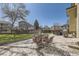 Outdoor patio with dining area, surrounded by a spacious, well-manicured lawn at 4708 Rock Pipit Ct, Highlands Ranch, CO 80126