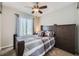 Comfortable bedroom featuring a ceiling fan and a large window for natural light at 4708 Rock Pipit Ct, Highlands Ranch, CO 80126