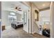 Hallway leading to a well-lit bedroom with vaulted ceilings and an adjacent staircase at 4708 Rock Pipit Ct, Highlands Ranch, CO 80126