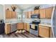 Modern kitchen featuring stainless steel appliances and wooden cabinetry at 4708 Rock Pipit Ct, Highlands Ranch, CO 80126