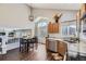 Bright kitchen with stainless steel appliances, granite counters, and adjacent dining area with high ceilings at 4708 Rock Pipit Ct, Highlands Ranch, CO 80126