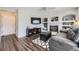 Inviting living room with fireplace, built-in shelves, and dark hardwood floors at 4708 Rock Pipit Ct, Highlands Ranch, CO 80126