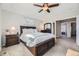 Main bedroom provides a ceiling fan, en-suite bathroom, and views into the hall at 4708 Rock Pipit Ct, Highlands Ranch, CO 80126