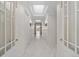 Hallway has white trim, sconces, French doors, and skylights at 5700 S Quebec St # A, Englewood, CO 80111