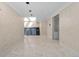 Hallway features white tile, decorative wall texture, and a solarium beyond at 5700 S Quebec St # A, Englewood, CO 80111