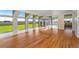 Living room with hardwood floors, solarium windows, and access to the turf rooftop at 5700 S Quebec St # A, Englewood, CO 80111
