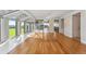 Bright living room with hardwood floors, solarium windows, and mountain views at 5700 S Quebec St # A, Englewood, CO 80111