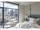 Bright bedroom with a large window showcasing a city view at 1901 Wazee St # 1020, Denver, CO 80202