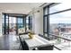 Open dining area with floor-to-ceiling windows offering expansive city views and access to a large balcony at 1901 Wazee St # 1020, Denver, CO 80202