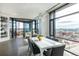 Dining area with floor-to-ceiling windows offering city views and a modern table with seating for six at 1901 Wazee St # 1020, Denver, CO 80202