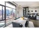 Stylish dining area with city views and an adjacent modern kitchen with stainless steel appliances at 1901 Wazee St # 1020, Denver, CO 80202