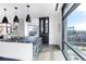 Modern kitchen with black marble island, pendant lighting, and city views through floor-to-ceiling windows at 1901 Wazee St # 1020, Denver, CO 80202