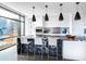 Modern kitchen featuring a sleek black marble island, stylish pendant lights, and floor-to-ceiling windows at 1901 Wazee St # 1020, Denver, CO 80202