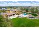 Aerial view of the back of home featuring a pool, hot tub, pergola, fire pit, and backyard at 8417 High Ridge Ct, Castle Pines, CO 80108